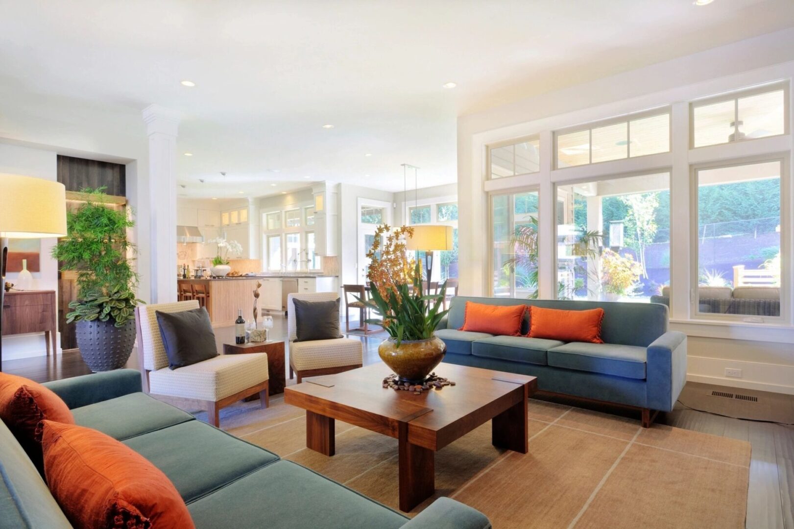 A living room with couches, chairs and tables.