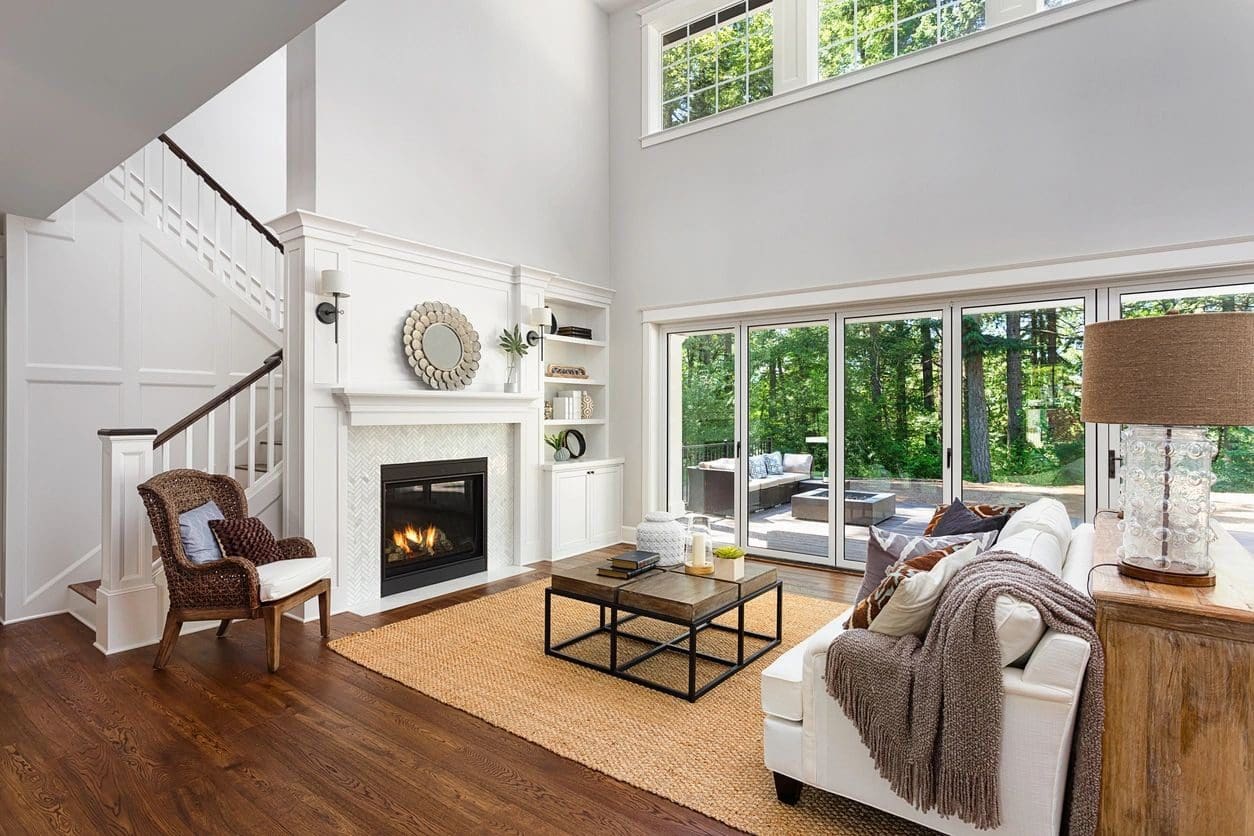 A living room with a fireplace and windows